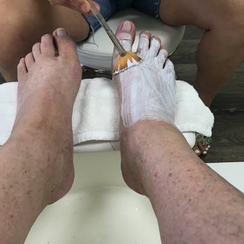 Premium Nail Salon - Daiana applies the lavender foot mask. - Nail Salons Near Me - Glendora , California Premium Nail Salon - Daiana applies the lavender foot mask. - Nail Salons Near Me - Glendora , California