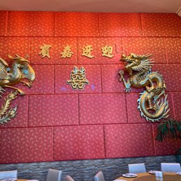two dragon heads on a red wall