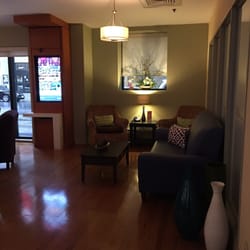Hotel Indigo Ottawa Downtown City Centre - The lobby has a whole lounge area with lots of seating and separated from the reception desk are by tree planters.