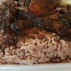 Taste of the tropic - Jerk chicken with cabbage and rice and beans. Juicy and falls off the bone. 2 thighs 2 legs.