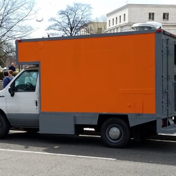 Le Mirage - an orange and gray truck parked on the side of the road - Food Trucks Near Me Le Mirage - an orange and gray truck parked on the side of the road - Food Trucks Near Me