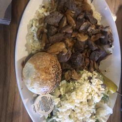 Zorba's Restaurant & Sports Bar - Beef and mushrooms over rice with salad.