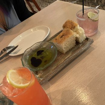 Bottiglia - Left - Right: Endless summer cocktail, focaccia bread, hibiscus paloma - Italian Near Me - Henderson, Nevada Bottiglia - Left - Right: Endless summer cocktail, focaccia bread, hibiscus paloma - Italian Near Me - Henderson, Nevada