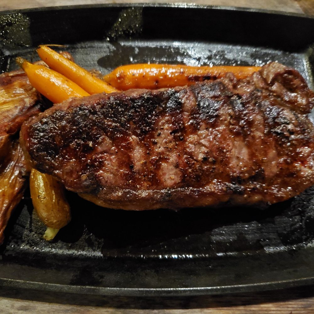 Bigfire - NY Strip Sirloin. Cooked Medium - American Near Me - Orlando, Florida Bigfire - NY Strip Sirloin. Cooked Medium - American Near Me - Orlando, Florida