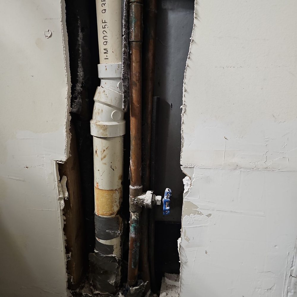 Drain line next to shut off valve.