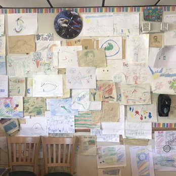 Clock Restaurant - a wall full of children's drawings - Breakfast & Brunch Near Me - Gainesville, Florida
