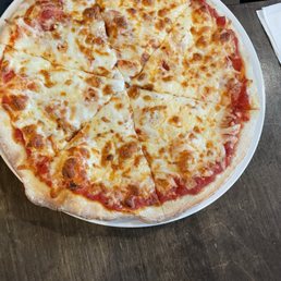 a cheese pizza on a plate a cheese pizza on a plate
