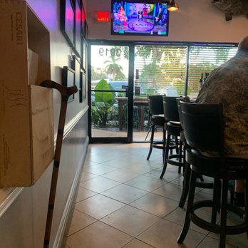 Chef Dee's - a man sitting at a table in a restaurant - Seafood Near Me - Lighthouse Point, Florida