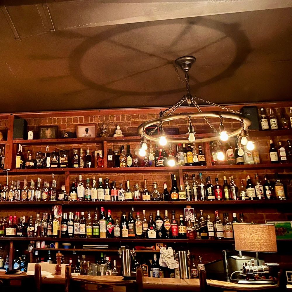 C & O Restaurant - a bar with a lot of bottles on the shelves - New American Near Me - Charlottesville, Virginia