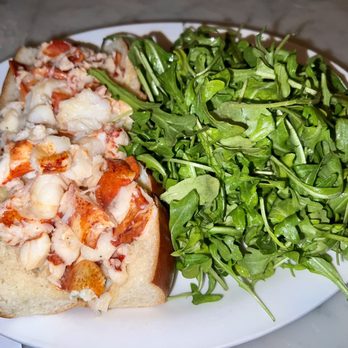 Neptune Oyster - Maine Lobster Roll sandwich with hot butter and a side of Arugula Salad. - Seafood Near Me - Boston, Massachusetts Neptune Oyster - Maine Lobster Roll sandwich with hot butter and a side of Arugula Salad. - Seafood Near Me - Boston, Massachusetts