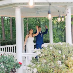 Evergreen Venue - Just married couple waving at guests from the gazebo