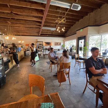 Indah Coffee - people sitting at tables in a coffee shop - Coffee Roasteries Near Me - Columbia, South Carolina