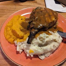 Pork chop with mashed potatoes, stuffing, butternut squash and gravy Pork chop with mashed potatoes, stuffing, butternut squash and gravy