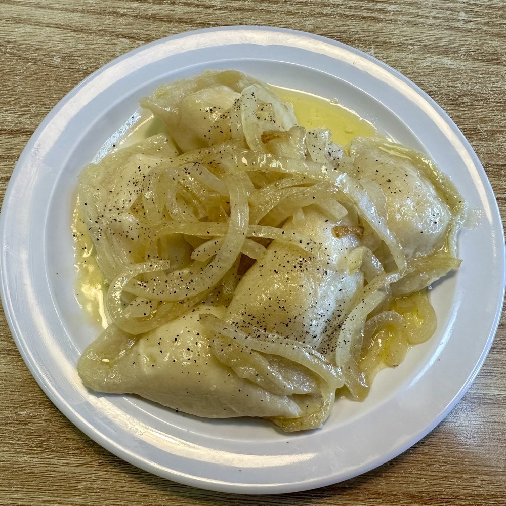 Potato and cheese pierogies with onions and butter. Potato and cheese pierogies with onions and butter.