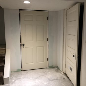 American Dreamers Renovations - an unfinished room with a door and stairs - General Contractors Near Me - Pittsburgh, Pennsylvania