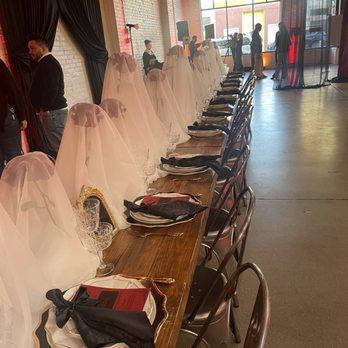 SKYLIGHT - A banquet table at an event venue is decorated with white veils, black napkins, and fine glassware, set for a formal gathering. - Venues & Event Spaces Near Me - Denver, Colorado
