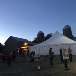 a group of people standing under a tent