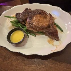 The Grocery Kitchen & Taproom - Cajun seasoned ribeye steak, butter, fresh green beans, and mashed potatoes.