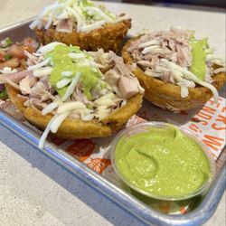 Los Pollos Rotisserie & Grill - Tostones Rellenos: stuffed Green plantains, with chicken and cheese, with avocado sauce.