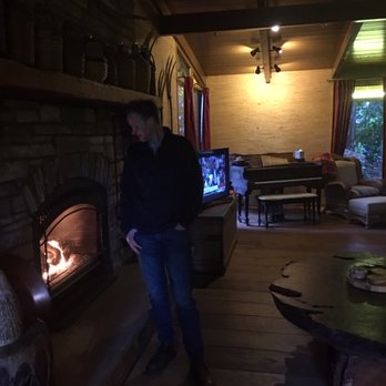 Occidental Guest House - Lovely fireplace, with brick sitting area in front of living room. - Guest Houses Near Me
