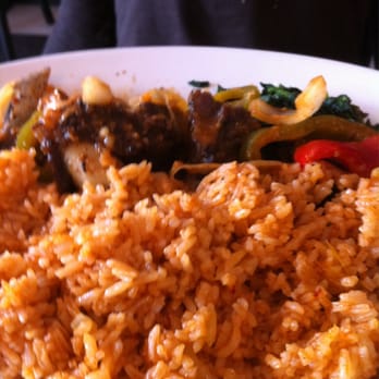 Roger Miller Restaurant - Grilled goat meat and jollof rice...despite color of rice it was bland but goat was pretty good but could use more seasoning. - African Near Me - Silver Spring, Maryland