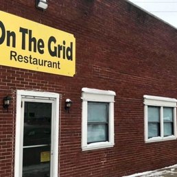 a brick building with a yellow sign