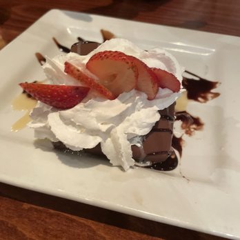 Wild River Grille - Starting bottom: warm brownie, Klondike bar, whip cream, strawberry, caramel and chocolate drizzle - New American Near Me - Reno, Nevada