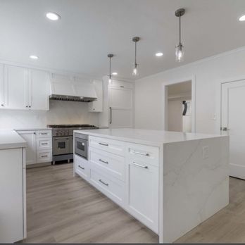Arevalos Fine Woodworking - a kitchen with white cabinets and a marble island - Cabinetry Near Me - San Carlos, California Arevalos Fine Woodworking - a kitchen with white cabinets and a marble island - Cabinetry Near Me - San Carlos, California