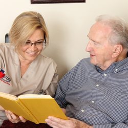 Caring Senior Service of Amarillo - Caring Senior Services caregiver reading with a client