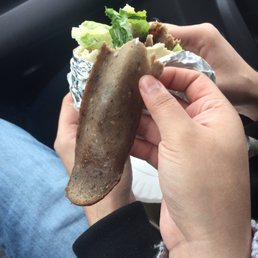 a person holding a piece of food a person holding a piece of food