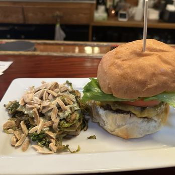 Alchemy - Apple Rum Burger with side of roasted Brussels sprouts with sauce and almonds. - New American Near Me - Madison, Wisconsin