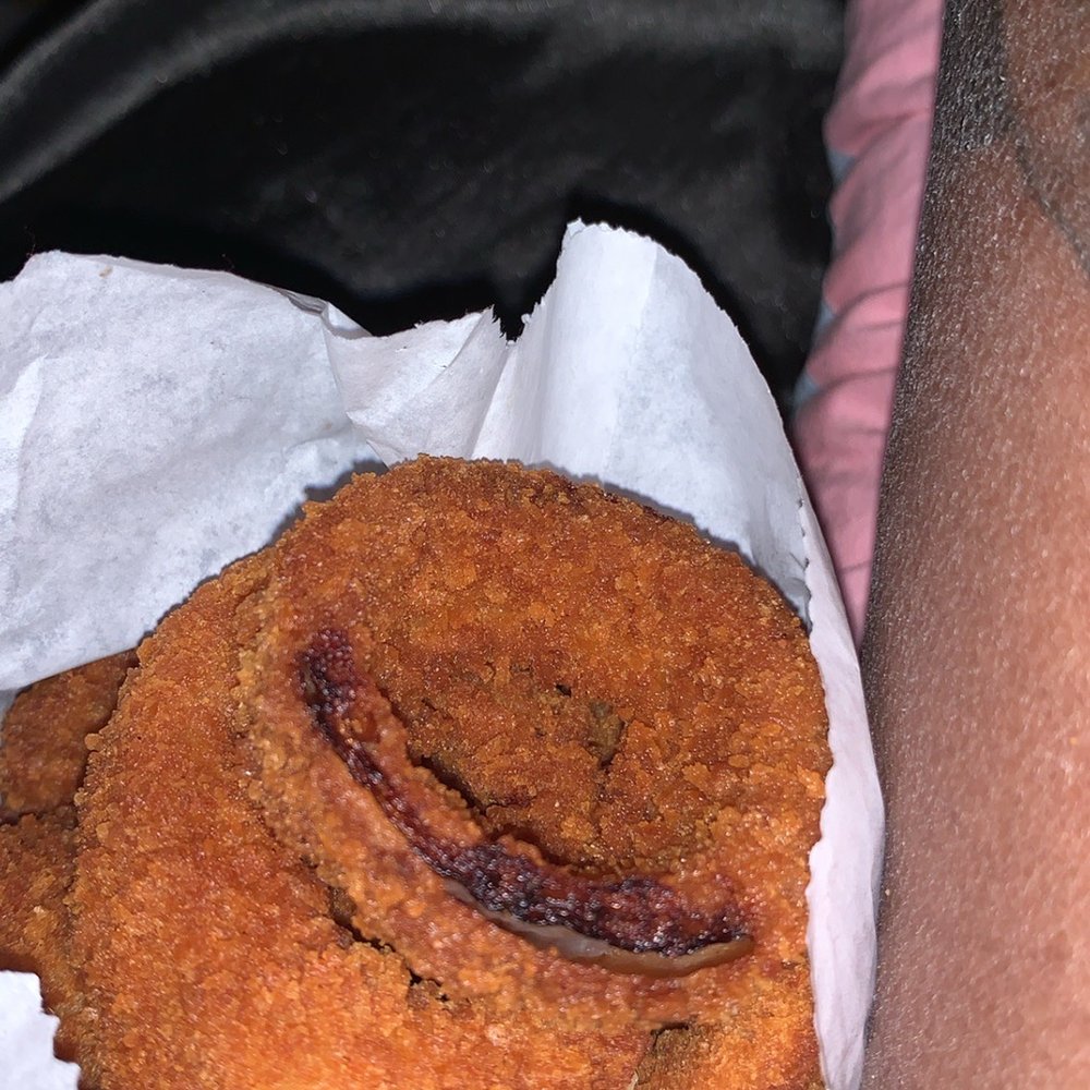 a person holding a pastry a person holding a pastry