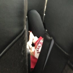 Girl pinning herself against seat to sleep... But also cause these are hammocks :-(