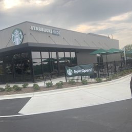 a man riding a skateboard in front of a starbucks a man riding a skateboard in front of a starbucks