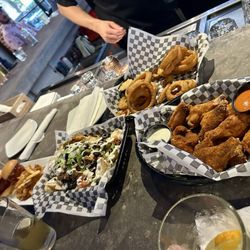 Wings and nachos and onion rings and meatball sliders