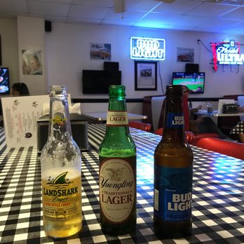 Pinehurst Pizza & Sports Bar - two bottles of beer on a checkered table - Pizza Near Me - Pinehurst, North Carolina Pinehurst Pizza & Sports Bar - two bottles of beer on a checkered table - Pizza Near Me - Pinehurst, North Carolina