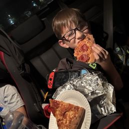Son eating some delicious pizza Son eating some delicious pizza