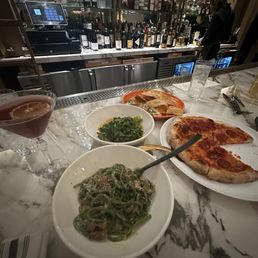 Pasta carbonara, pepperoni pizza, tabouli, and hummus. Pasta carbonara, pepperoni pizza, tabouli, and hummus.