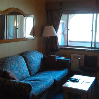 Olympic Village Inn - sofa bed in living room with balcony in background - Hotels Near Me - Olympic Valley, California Olympic Village Inn - sofa bed in living room with balcony in background - Hotels Near Me - Olympic Valley, California