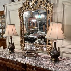 Lucullus Antiques - The self-delighting exuberance of this Louis XVI gilded mirror, alive with cupid's bow and pomegranates, is hard to resist.