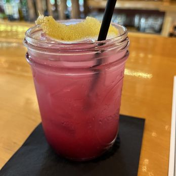 Deacon Street - a drink in a mason jar with a straw and a lemon garnish - Whiskey Bars Near Me - North Conway, New Hampshire