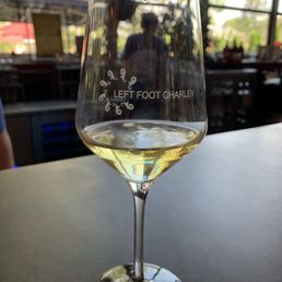 a glass of wine on a table a glass of wine on a table