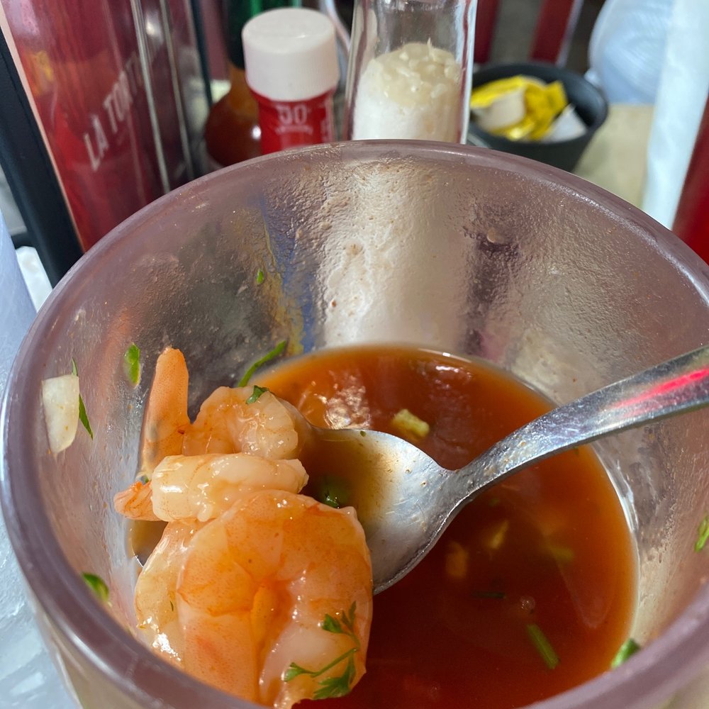 a bowl of soup with a spoon in it a bowl of soup with a spoon in it