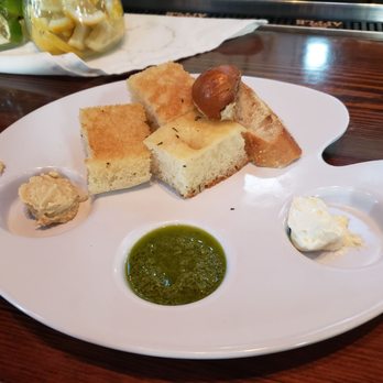 Ember Woodfire Grill - Their superior take on a bread basket with hummus, pesto, and butter - New American Near Me - Livonia, New York