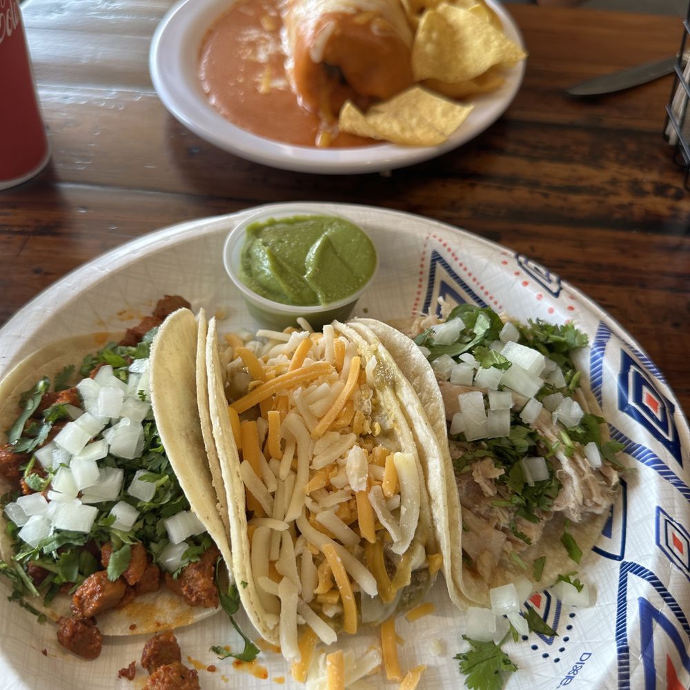 Background - wet carne asada burrito, foreground - street tacos