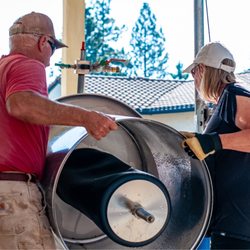 Owners Marty and Eileen setting up the wine press