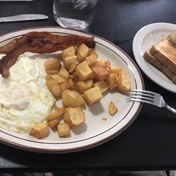 Cafe 110 West - Hubby's standard breakfast out order - two eggs over easy, bacon, cafe potatoes, and wheat toast. Cooked perfectly and it tasted great! - American Near Me - Odell, Illinois
