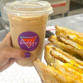 Daddy’s Breakfast and Espresso - a hand holding a sandwich - Breakfast & Brunch Near Me Daddy’s Breakfast and Espresso - a hand holding a sandwich - Breakfast & Brunch Near Me
