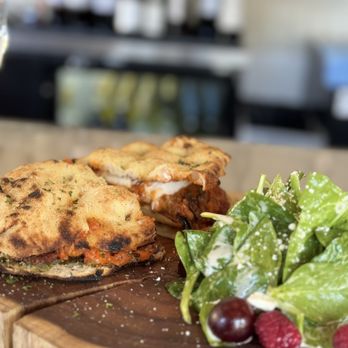 IL  Posto - Panuozzo with milanese and eggplant  and spinach salad - Italian Near Me - San Diego, California