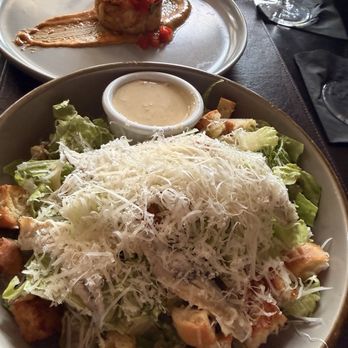 Oak Steakhouse - Caesar dressing on the side with a crab cake. - Steakhouses Near Me - Charleston, South Carolina Oak Steakhouse - Caesar dressing on the side with a crab cake. - Steakhouses Near Me - Charleston, South Carolina